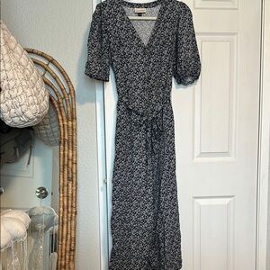 Floral navy blue and white jumpsuit with front pockets and buttons